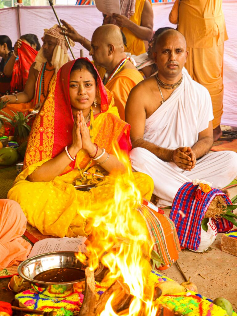 A Hindu couple participates in a vibrant religious ceremony in Dhaka, Bangladesh.