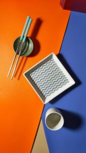 Stylish Japanese table setting with chopsticks and vibrant colors.