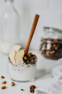 Fresh granola yogurt parfait topped with apple slices, perfect for a nutritious breakfast.
